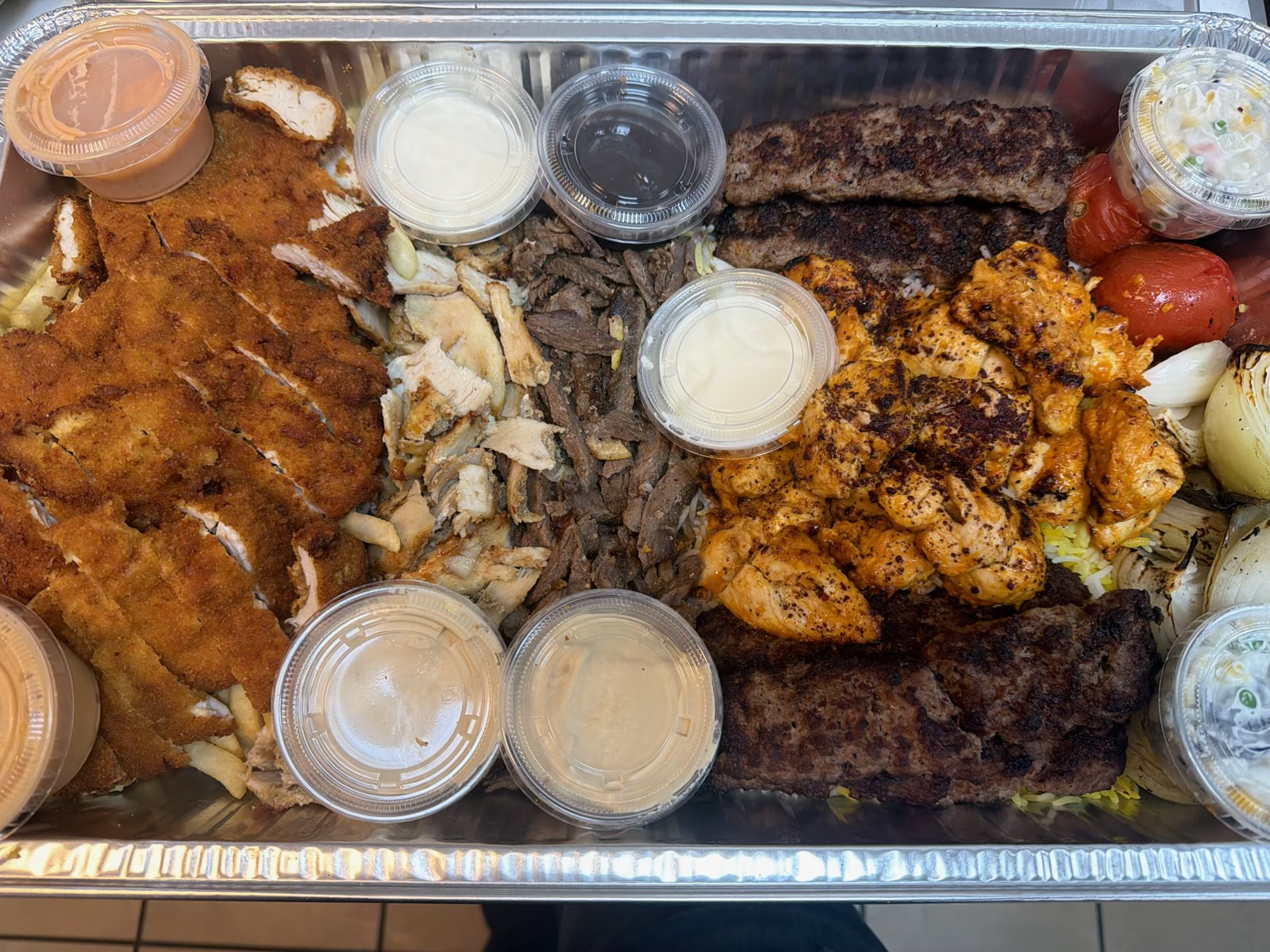 Mixed grill catering tray with kebab, chicken tikka, shawarma and escalope