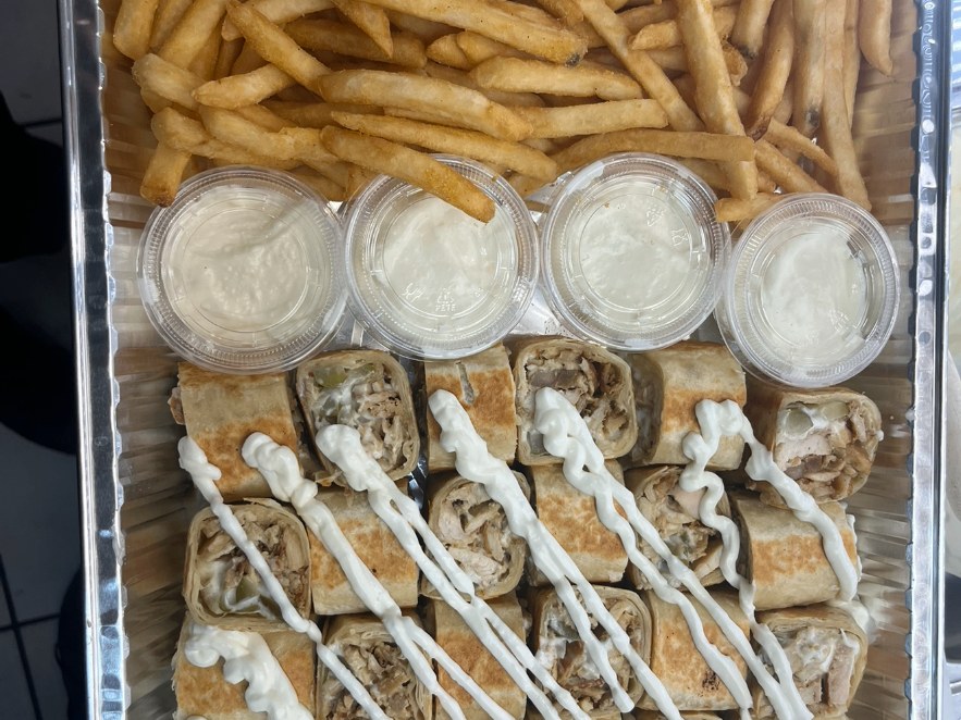 Chicken shawarma rolls with garlic sauce and fries
