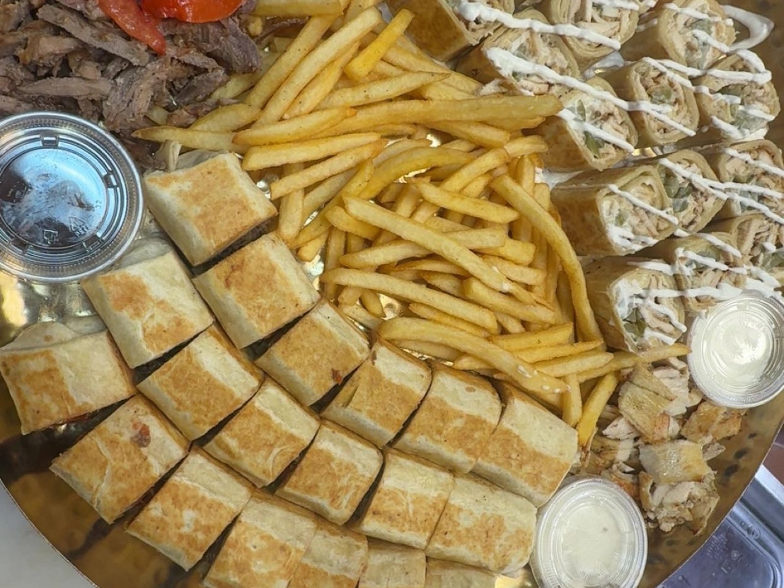 Golden platter of shawarma wraps, fries and shredded meats