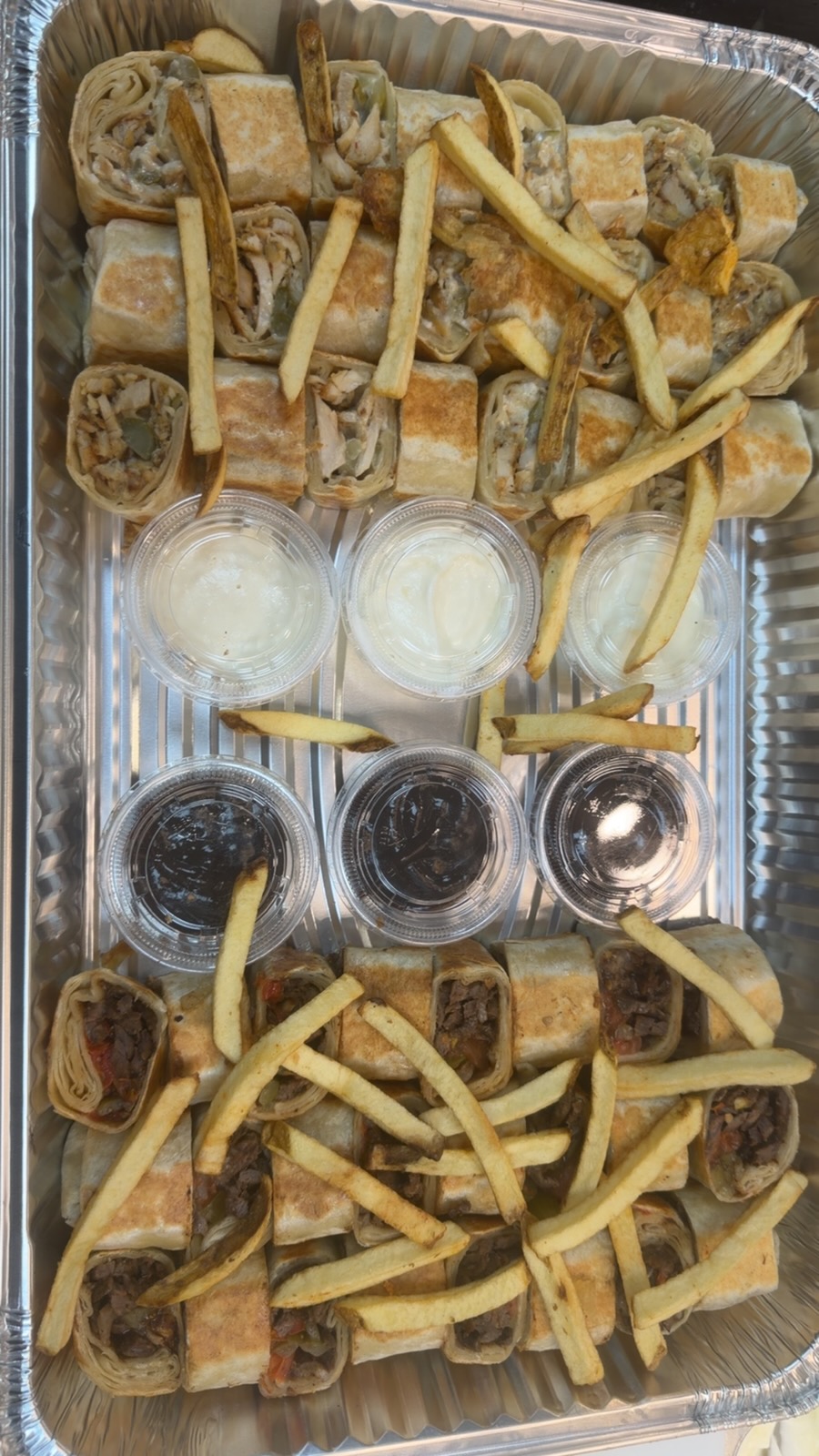 Mixed chicken and beef shawarma wraps catering tray with fries and sauces