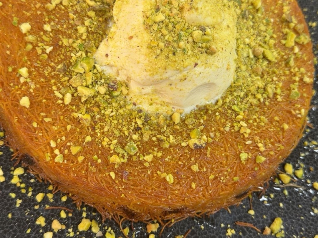 Fresh kunafa topped with pistachio and ice cream